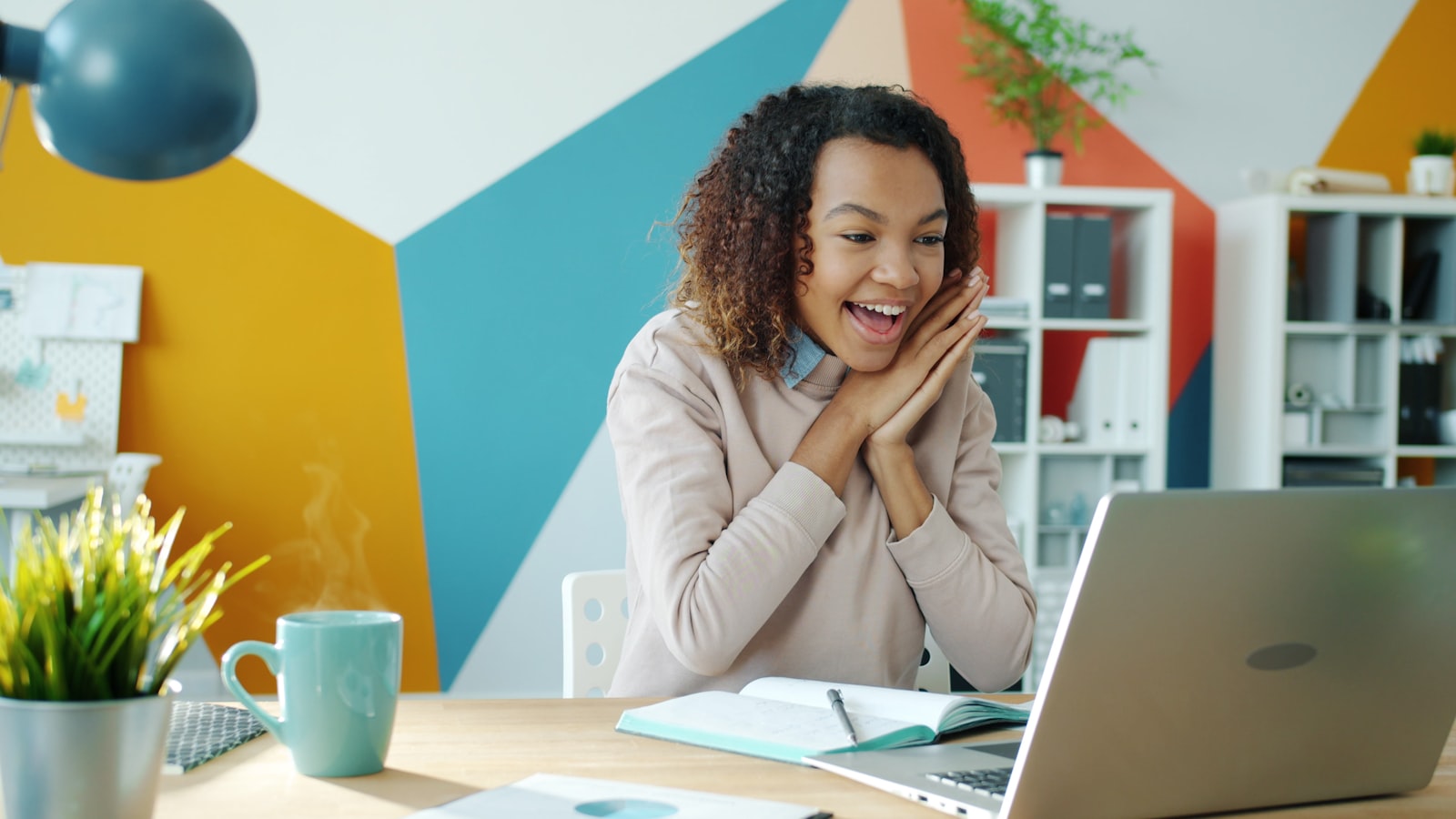 Short-term rental host reviewing bookings on a laptop in a sunny home office — STR Squad in use